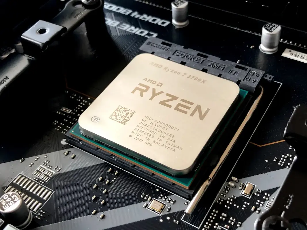 Processador AMD Ryzen instalado em uma placa-mãe, mostrando o soquete e detalhes dos circuitos eletrônicos ao redor.